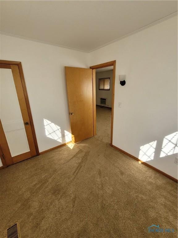 621 Nevada St, Toledo, OH 43605 - carpeted spare room with baseboards, visible vents, and crown molding