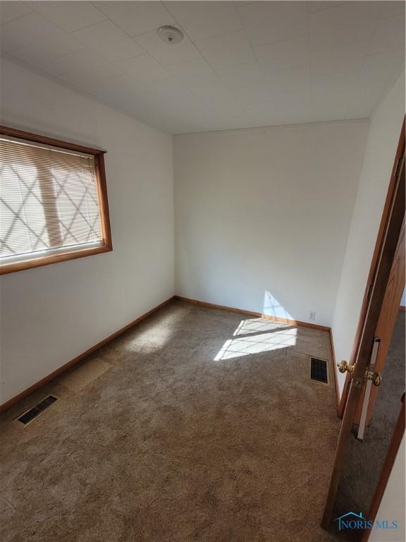 621 Nevada St, Toledo, OH 43605 - spare room with carpet flooring, baseboards, and visible vents