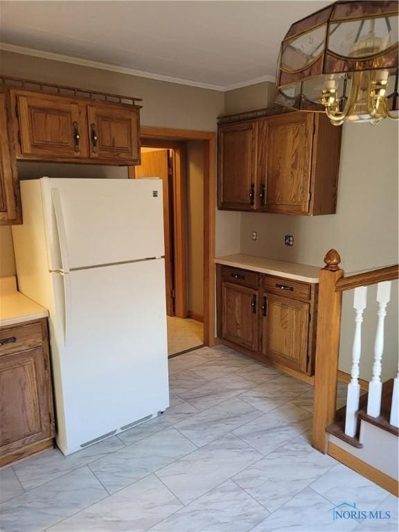 621 Nevada St, Toledo, OH 43605 - kitchen featuring freestanding refrigerator, marble finish floor, an inviting chandelier, and brown cabinets