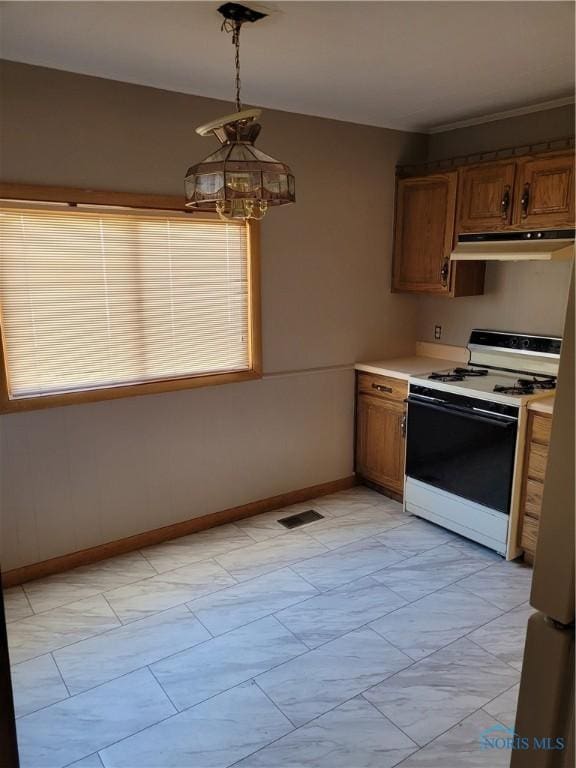 621 Nevada St, Toledo, OH 43605 - kitchen featuring light countertops, a chandelier, under cabinet range hood, visible vents, and white gas stove