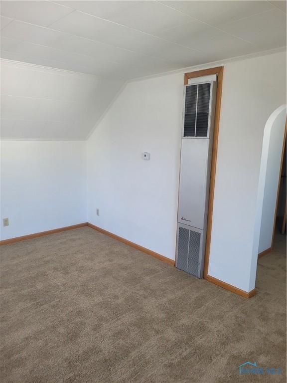 621 Nevada St, Toledo, OH 43605 - additional living space featuring vaulted ceiling, carpet flooring, a heating unit, baseboards, and arched walkways