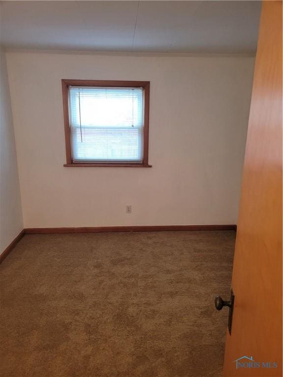 621 Nevada St, Toledo, OH 43605 - carpeted empty room featuring baseboards and crown molding