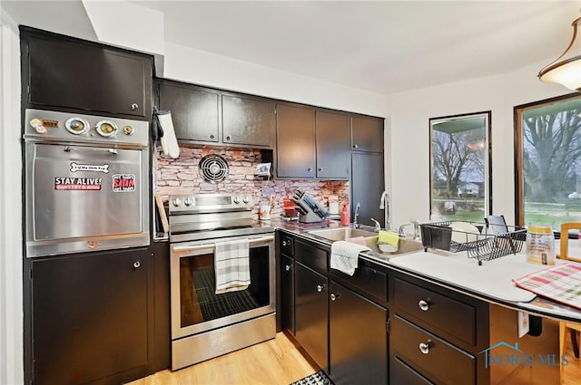284 E Findlay St, Sugar Creek Township, OH 45893 - kitchen with decorative backsplash, stainless steel electric range oven, light wood finished floors, dark brown cabinets, and a sink