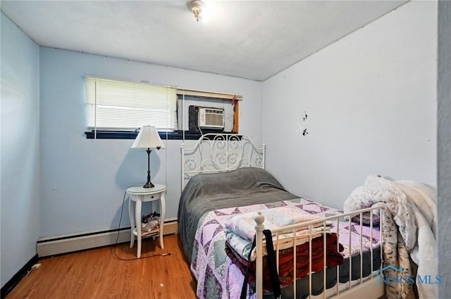 284 E Findlay St, Sugar Creek Township, OH 45893 - bedroom with cooling unit, wood finished floors, and a baseboard radiator