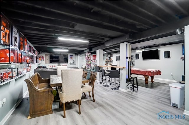 dining space with wet bar, billiards, baseboards, and wood finished floors