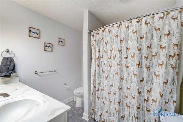 bathroom featuring vanity, toilet, baseboards, a textured ceiling, and curtained shower