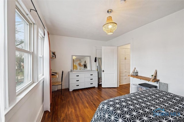 bedroom with multiple windows, a notable chandelier, baseboards, and dark wood-style flooring