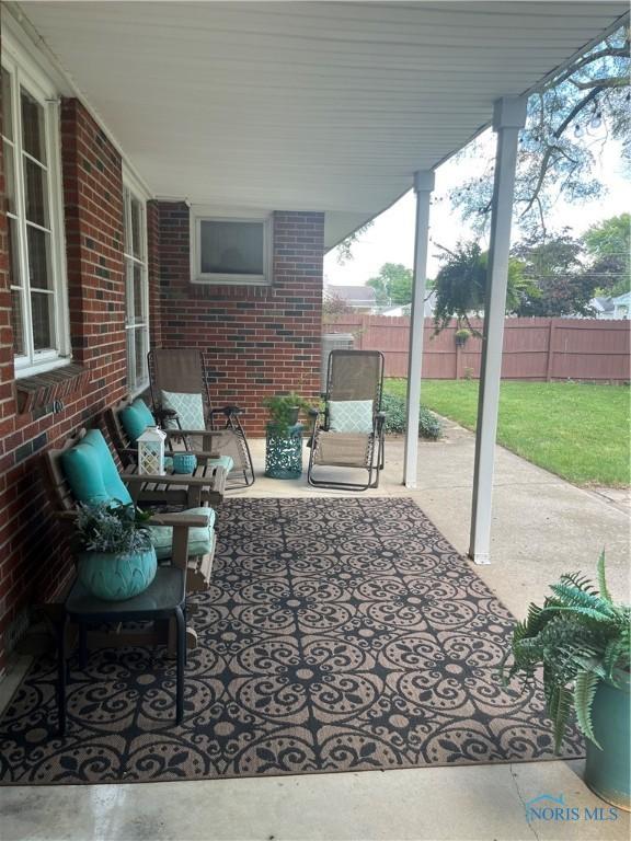 view of patio / terrace featuring an outdoor hangout area and fence