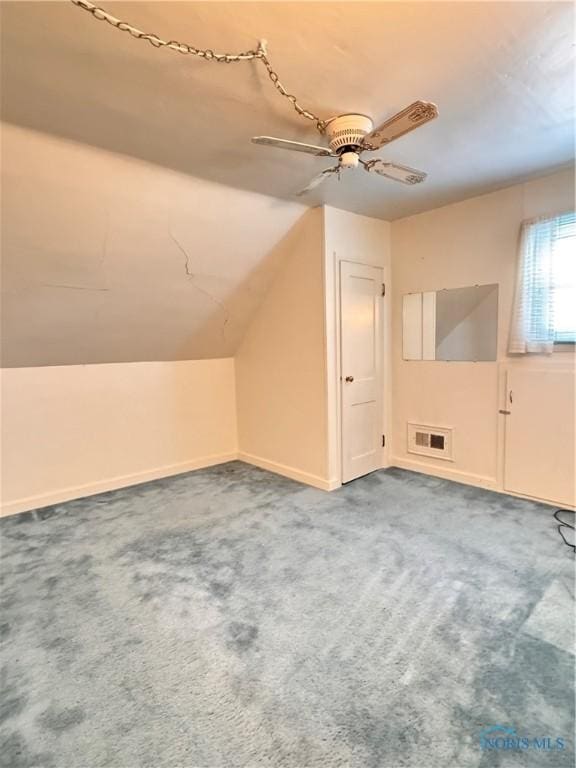 bonus room featuring carpet flooring, a ceiling fan, lofted ceiling, baseboards, and visible vents