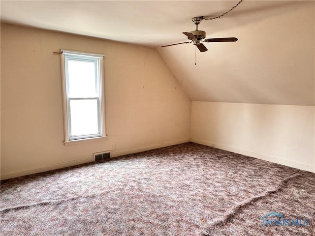 additional living space featuring visible vents, carpet, vaulted ceiling, and ceiling fan