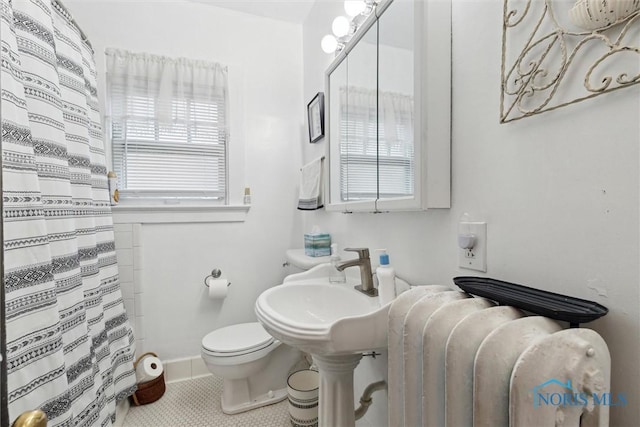 full bath featuring radiator, a shower with curtain, tile patterned flooring, toilet, and baseboards