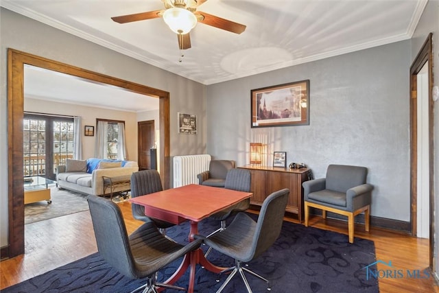dining room featuring ceiling fan, crown molding, and wood finished floors