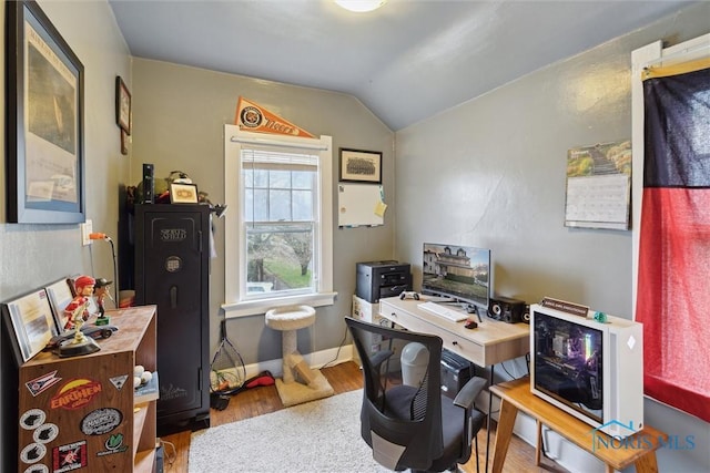 office with baseboards, vaulted ceiling, and wood finished floors