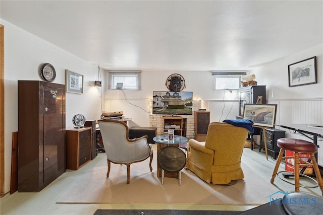 living room featuring plenty of natural light and a brick fireplace