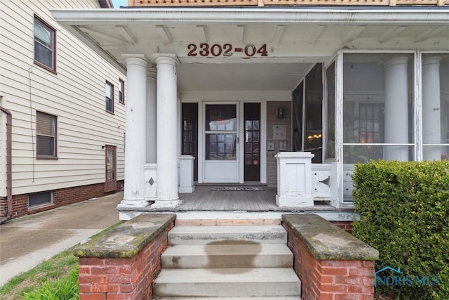 view of exterior entry featuring a porch