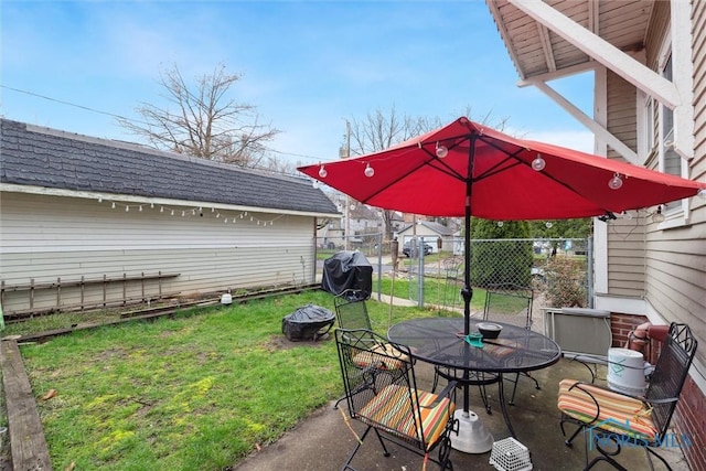 view of patio featuring an outdoor fire pit, grilling area, fence, and outdoor dining area