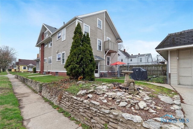 view of home's exterior with a residential view and fence