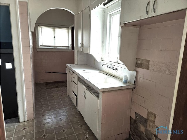 bathroom with tile patterned flooring and a sink