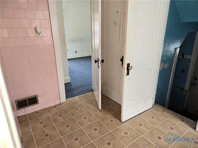 interior space featuring tile patterned flooring and visible vents