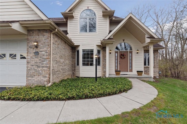 2016 Austin Bluffs Ct, Toledo, OH 43615 - traditional-style house with brick siding, an attached garage, and a front lawn