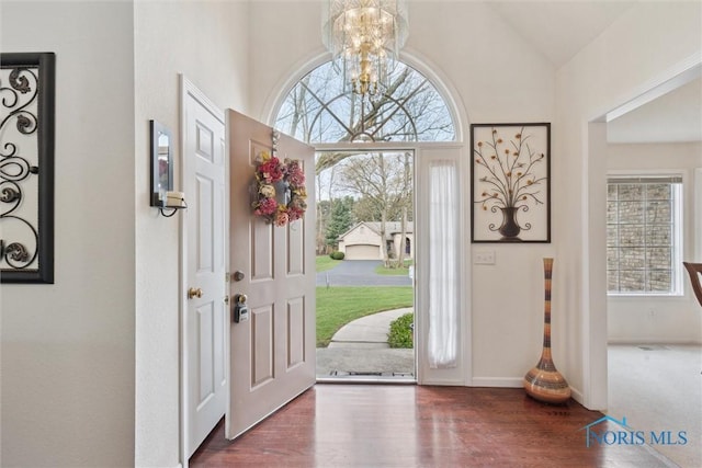 2016 Austin Bluffs Ct, Toledo, OH 43615 - foyer entrance with high vaulted ceiling, an inviting chandelier, baseboards, and wood finished floors
