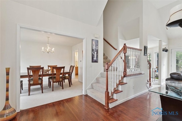 2016 Austin Bluffs Ct, Toledo, OH 43615 - interior space with baseboards, an inviting chandelier, wood finished floors, and stairs