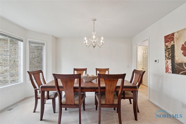 2016 Austin Bluffs Ct, Toledo, OH 43615 - dining area with visible vents, light colored carpet, an inviting chandelier, and baseboards