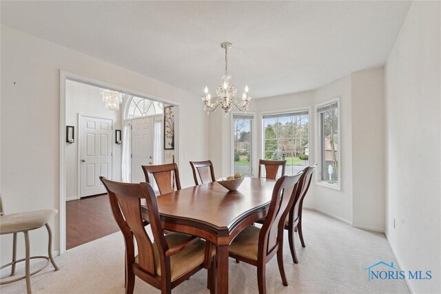 2016 Austin Bluffs Ct, Toledo, OH 43615 - dining area with a wealth of natural light, a notable chandelier, and light colored carpet