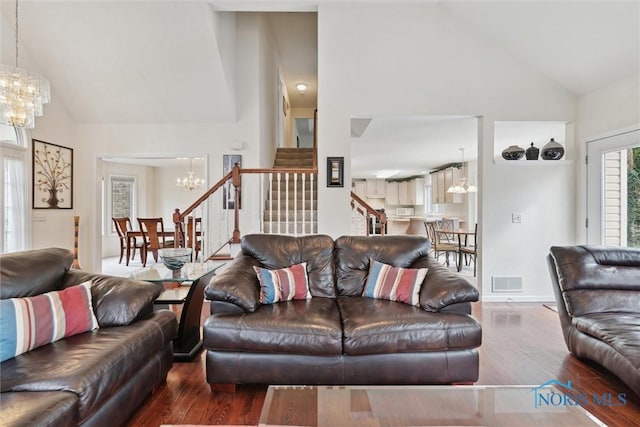 2016 Austin Bluffs Ct, Toledo, OH 43615 - living area with visible vents, a chandelier, wood finished floors, stairs, and high vaulted ceiling