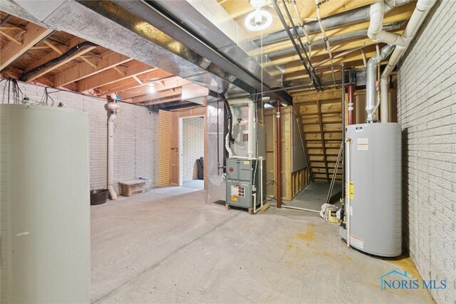 2016 Austin Bluffs Ct, Toledo, OH 43615 - unfinished below grade area with water heater, heating unit, and brick wall