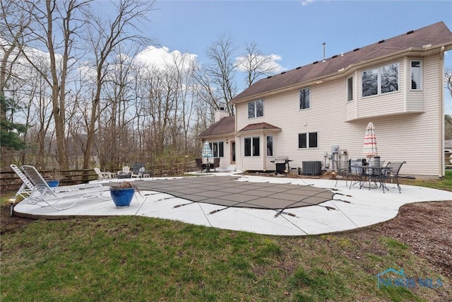 2016 Austin Bluffs Ct, Toledo, OH 43615 - back of house featuring central air condition unit, a patio area, fence, a chimney, and a covered pool