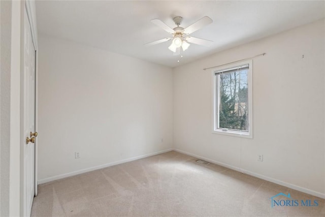 2016 Austin Bluffs Ct, Toledo, OH 43615 - empty room with baseboards, a ceiling fan, and light carpet