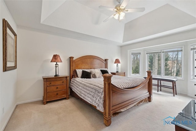 2016 Austin Bluffs Ct, Toledo, OH 43615 - bedroom featuring a tray ceiling, light colored carpet, baseboards, and a ceiling fan