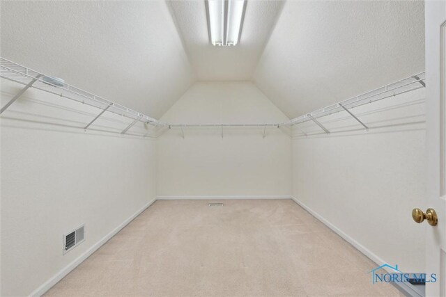 2016 Austin Bluffs Ct, Toledo, OH 43615 - spacious closet with visible vents, light colored carpet, and vaulted ceiling