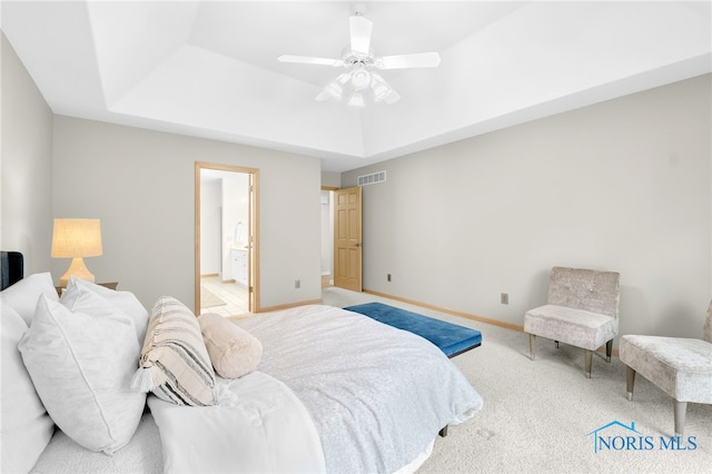 bedroom featuring a raised ceiling, carpet, baseboards, and visible vents