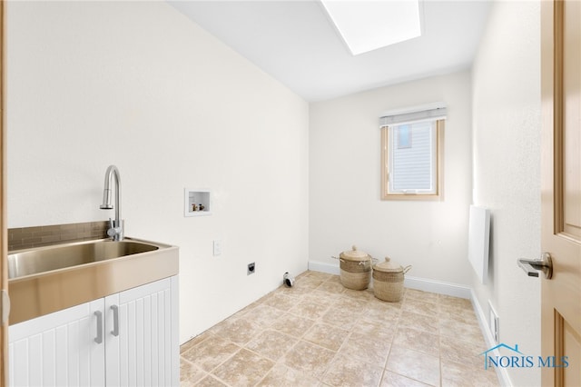 washroom featuring a sink, electric dryer hookup, baseboards, cabinet space, and hookup for a washing machine