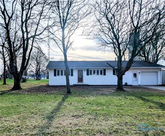 ranch-style home featuring a front yard and an attached garage