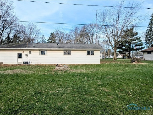 view of property exterior with central air condition unit and a yard