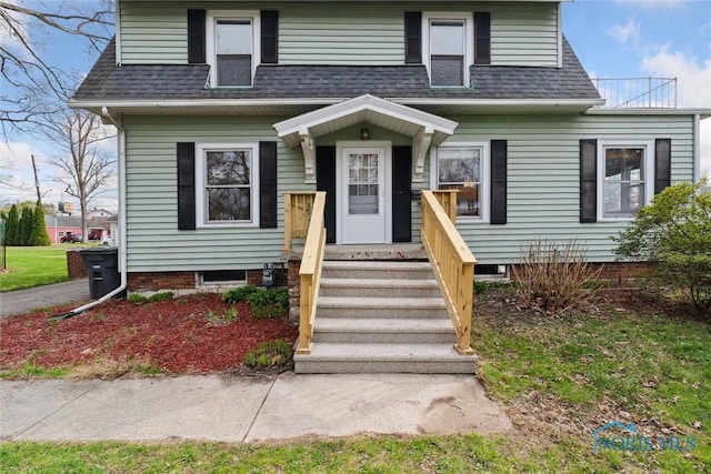 view of front of home featuring roof with shingles