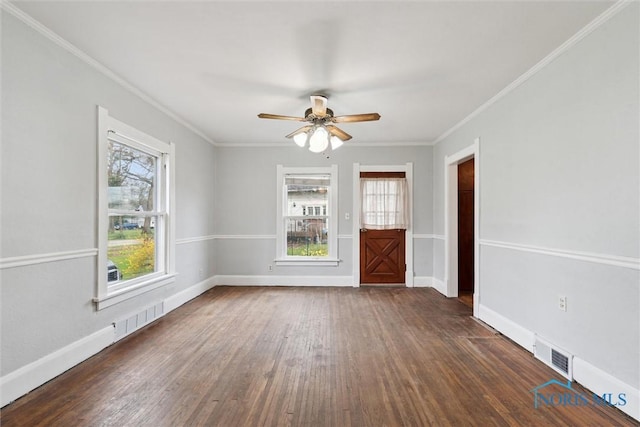 spare room with baseboards, visible vents, a ceiling fan, and dark wood-style floors