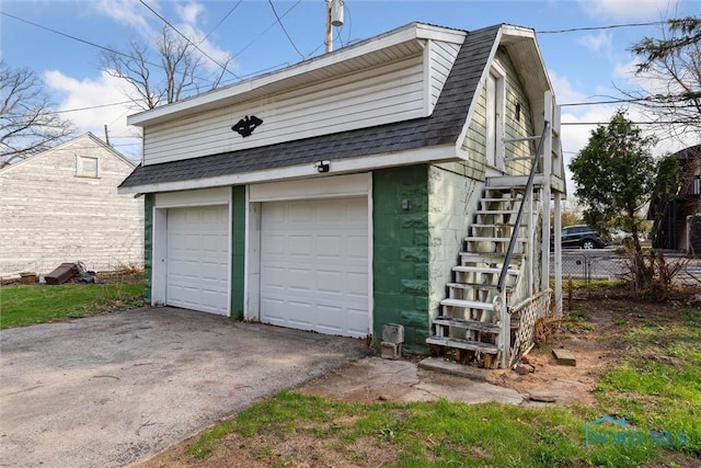 detached garage featuring fence