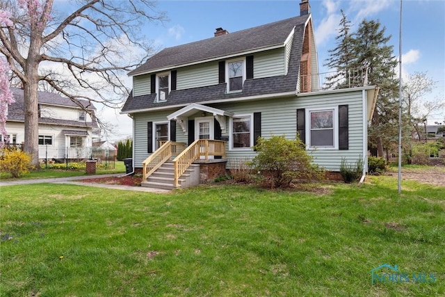 dutch colonial with a chimney, roof with shingles, and a front yard