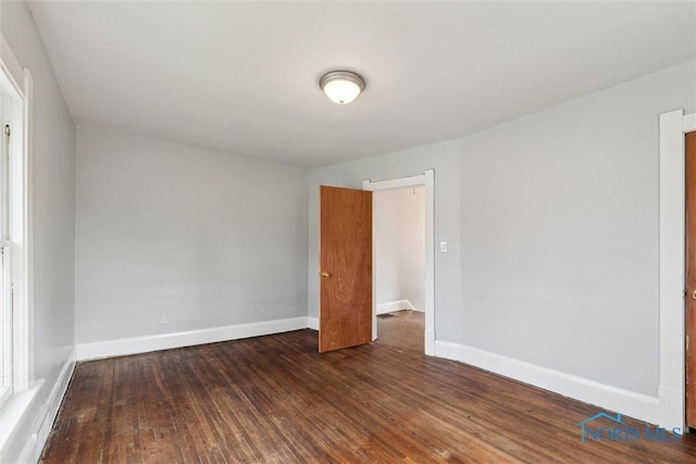 unfurnished room featuring wood finished floors and baseboards