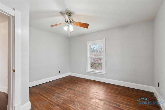 spare room with hardwood / wood-style floors, baseboards, and ceiling fan