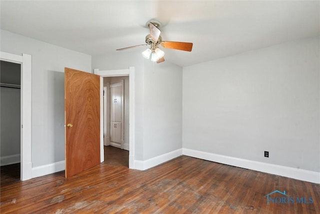 unfurnished bedroom with wood-type flooring, baseboards, a ceiling fan, and a closet
