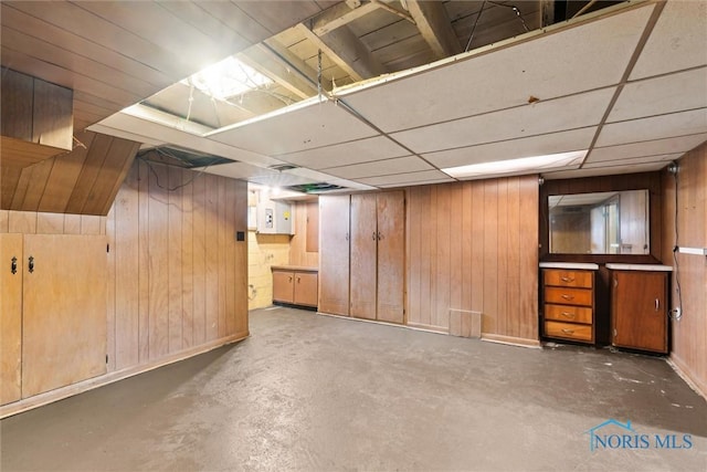 finished basement featuring wooden walls