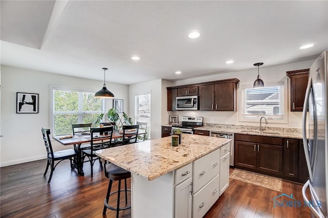 630 Weatherby Ct, Findlay, OH 45840 - kitchen with dark wood-style flooring, stainless steel appliances, a sink, light stone countertops, and dark brown cabinets