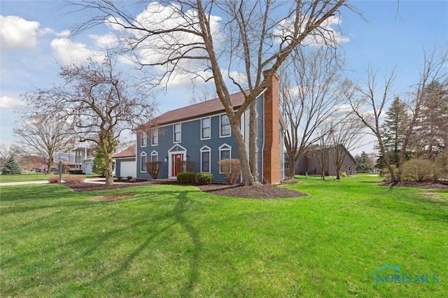 3011 Heather Downs Dr, Findlay, OH 45840 - colonial-style house with a garage, a chimney, and a front lawn