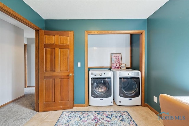 3011 Heather Downs Dr, Findlay, OH 45840 - clothes washing area with light tile patterned floors, washing machine and dryer, laundry area, and baseboards