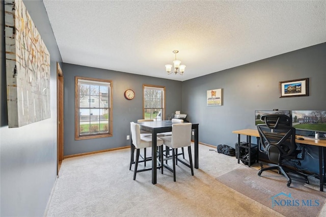 3011 Heather Downs Dr, Findlay, OH 45840 - dining space with a chandelier, baseboards, a textured ceiling, and carpet floors